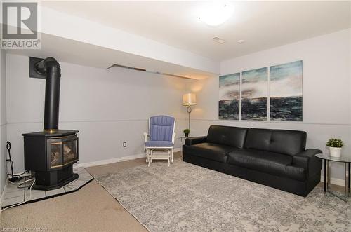 Living room with a wood stove and light colored carpet - 79 Braeheid Avenue Avenue Unit# 6, Hamilton, ON - Indoor