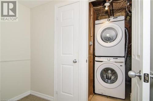 Laundry room featuring stacked washing maching and dryer - 79 Braeheid Avenue Avenue Unit# 6, Hamilton, ON - Indoor Photo Showing Laundry Room