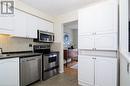 Kitchen with light wood-type flooring, stainless steel appliances, white cabinetry, and sink - 79 Braeheid Avenue Avenue Unit# 6, Hamilton, ON  - Indoor Photo Showing Kitchen With Stainless Steel Kitchen 