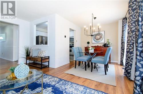 Dining room with hardwood / wood-style floors and an inviting chandelier - 79 Braeheid Avenue Avenue Unit# 6, Hamilton, ON - Indoor Photo Showing Dining Room