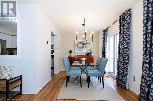 Dining area with hardwood / wood-style floors and a notable chandelier - 79 Braeheid Avenue Avenue Unit# 6, Hamilton, ON - Indoor Photo Showing Dining Room