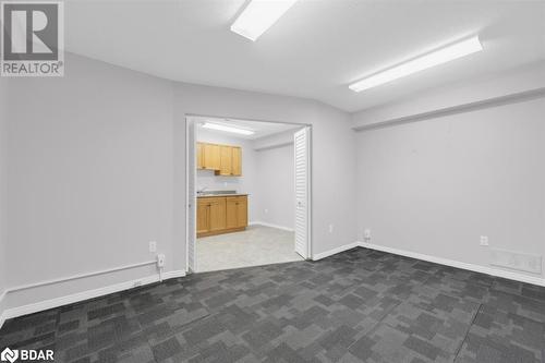 Empty room with dark carpet - 108 Russell Street N, Madoc, ON 