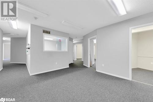 Empty room with dark carpet - 108 Russell Street N, Madoc, ON 