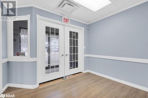 Doorway to outside with hardwood / wood-style floors, french doors, and ornamental molding - 108 Russell Street N, Madoc, ON 