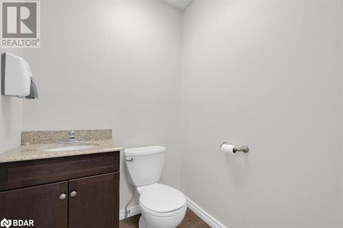 Bathroom featuring vanity, toilet, and wood-type flooring - 108 Russell Street N, Madoc, ON 