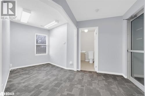 Unfurnished bedroom featuring connected bathroom and dark carpet - 108 Russell Street N, Madoc, ON - Indoor Photo Showing Other Room