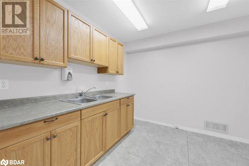 Kitchen featuring light brown cabinetry, sink, and light tile patterned floors - 108 Russell Street N, Madoc, ON - Indoor Photo Showing Kitchen With Double Sink