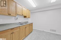 Kitchen featuring light brown cabinetry, sink, and light tile patterned floors - 