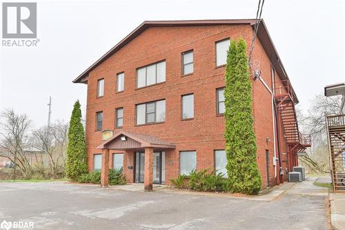 View of building exterior featuring central AC unit - 108 Russell Street N, Madoc, ON - Outdoor With Facade