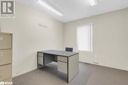 Unfurnished office featuring light carpet - 