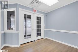 Doorway to outside featuring hardwood / wood-style floors, french doors, and ornamental molding - 