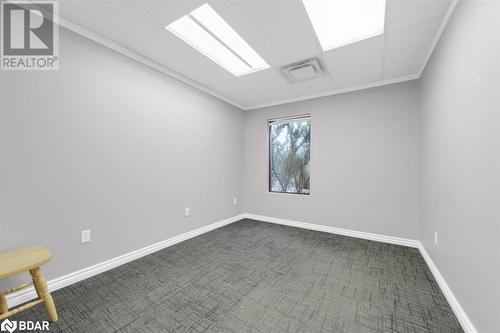 Spare room featuring dark carpet and crown molding - 108 Russell Street N, Madoc, ON - Indoor Photo Showing Other Room