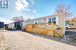 View of front of home with a wooden deck - 