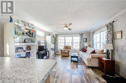 Living room with a textured ceiling, dark hardwood / wood-style floors, and crown molding - 99 Fourth Conc Road, Burford, ON - Indoor Photo Showing Living Room