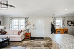 Living room featuring crown molding. - 