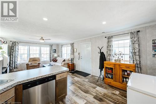 Kitchen with ornamental molding, stainless steel dishwasher and ceiling fan. - 99 Fourth Conc Road, Burford, ON - Indoor Photo Showing Kitchen