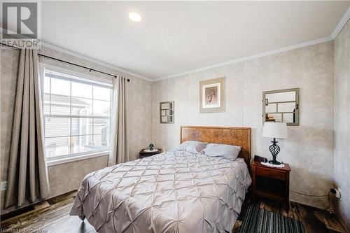 Bedroom featuring wood-type flooring and ornamental molding - 99 Fourth Conc Road, Burford, ON - Indoor Photo Showing Bedroom