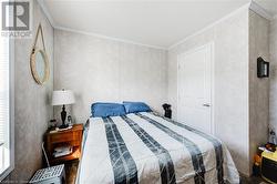 Bedroom with dark hardwood and crown molding - 