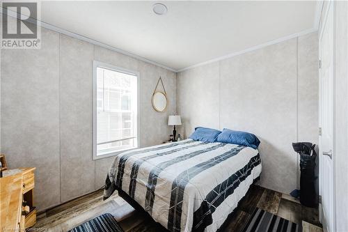 Bedroom with wood-type flooring and ornamental molding - 99 Fourth Conc Road, Burford, ON - Indoor Photo Showing Bedroom