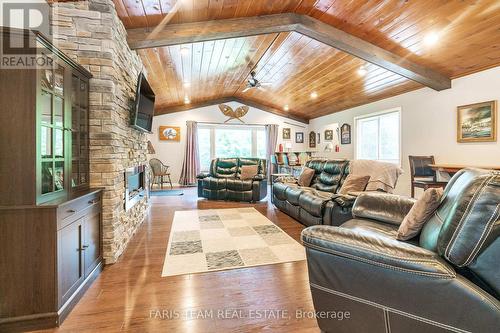 328 Peek-A-Boo Trail, Tiny, ON - Indoor Photo Showing Living Room With Fireplace