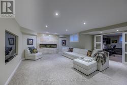 LOWER LEVEL FAMILY ROOM;  GRANITE WALL & FIREPL - 