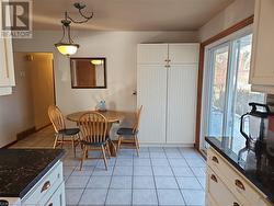 Dining area featuring light tile patterned floors - 