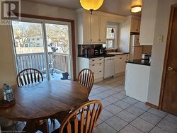 Tiled dining area with plenty of natural light and sink - 