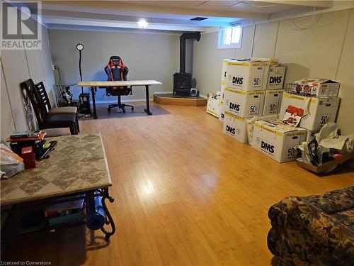 Recreation room with hardwood / wood-style flooring and a wood stove - 140 Alvin Street, Waterloo, ON - Indoor Photo Showing Basement