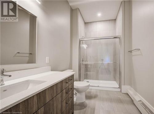 Ensuite to primary bedroom featuring tiled shower with glass doors. - 28 Main Street Unit# 1, Cambridge, ON - Indoor Photo Showing Bathroom