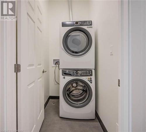 New stacked full-size Electrolux washer and dryer. - 28 Main Street Unit# 1, Cambridge, ON - Indoor Photo Showing Laundry Room