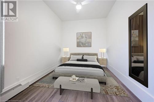 Bedroom with wood-type flooring, a baseboard radiator, and ceiling fan - 28 Main Street Unit# 1, Cambridge, ON - Indoor Photo Showing Bedroom