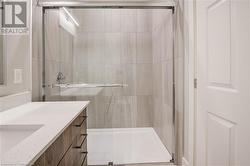 Main Bath tiled shower with glass doors. - 