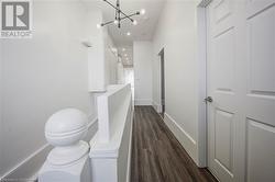 Corridor featuring a chandelier and laminate floor - 