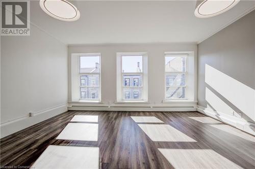 Featuring laminate wood-style floors and crown molding - 28 Main Street Unit# 1, Cambridge, ON - Indoor Photo Showing Other Room