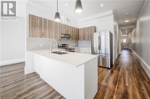 Kitchen with quartz countertops, tiled back splash and custom cabinetry - 28 Main Street Unit# 1, Cambridge, ON - Indoor Photo Showing Kitchen With Stainless Steel Kitchen With Double Sink With Upgraded Kitchen