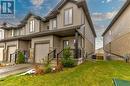 View of front of home with cooling unit, a front yard, and a garage - 1023 Devonshire Avenue Unit# 5, Woodstock, ON  - Outdoor 