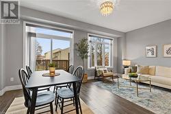 Dining area featuring a wealth of natural light, dark hardwood / wood-style floors, and a notable chandelier - 