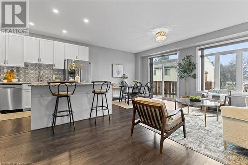 Living room with a chandelier and dark hardwood / wood-style floors - 1023 Devonshire Avenue Unit# 5, Woodstock, ON - Indoor