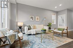 Living room featuring dark wood-type flooring - 