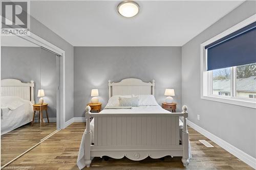 Bedroom featuring a closet and hardwood / wood-style flooring - 1023 Devonshire Avenue Unit# 5, Woodstock, ON - Indoor Photo Showing Bedroom