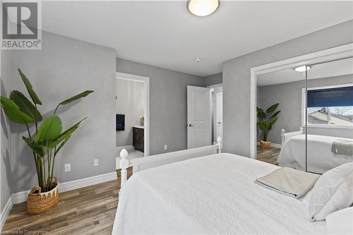 Bedroom with connected bathroom and wood-type flooring - 1023 Devonshire Avenue Unit# 5, Woodstock, ON - Indoor Photo Showing Bedroom