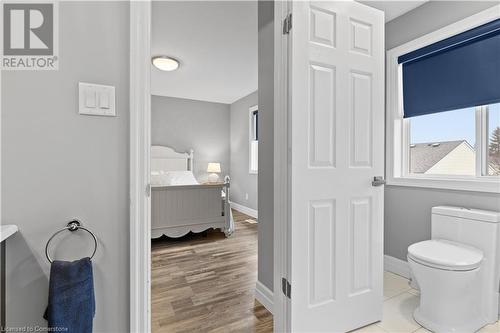 Bathroom featuring hardwood / wood-style floors and toilet - 1023 Devonshire Avenue Unit# 5, Woodstock, ON - Indoor Photo Showing Bathroom