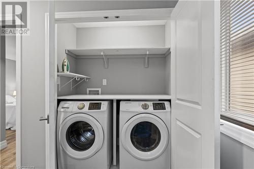 Washroom with light hardwood / wood-style flooring, a healthy amount of sunlight, and independent washer and dryer - 1023 Devonshire Avenue Unit# 5, Woodstock, ON - Indoor Photo Showing Laundry Room