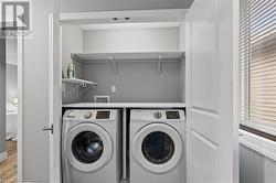 Washroom with light hardwood / wood-style flooring, a healthy amount of sunlight, and independent washer and dryer - 