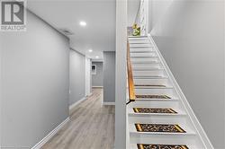 Stairs featuring hardwood / wood-style floors - 