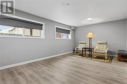 Sitting room featuring plenty of natural light and light wood-type flooring - 