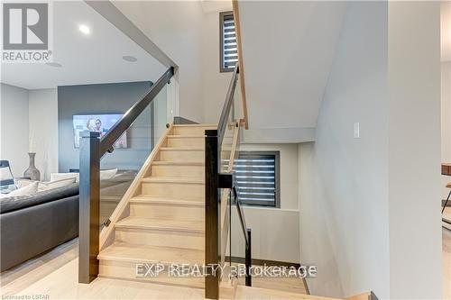 Custom stairs, extra wide with glass rail - 86 Optimist Drive, Southwold (Talbotville), ON - Indoor Photo Showing Other Room