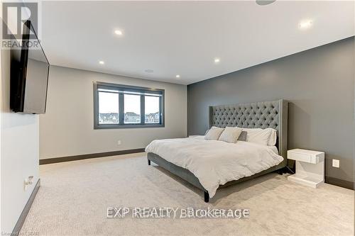 Massive primary bedroom with speakers and TV - 86 Optimist Drive, Southwold (Talbotville), ON - Indoor Photo Showing Bedroom