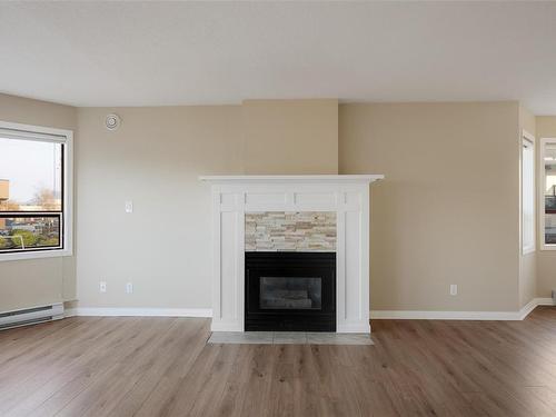 205-9711 Fifth St, Sidney, BC - Indoor Photo Showing Living Room With Fireplace