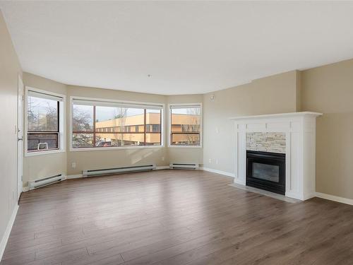 205-9711 Fifth St, Sidney, BC - Indoor Photo Showing Living Room With Fireplace